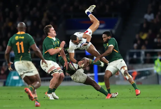 Siya Kolisi of South Africa tackles Joe Marchant of England