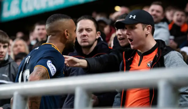 Aberdeen's Funso Ojo and a fan deep in argument