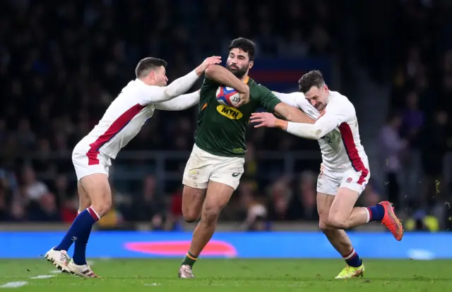 Damian de Allende of South Africa is tackled by Ben Youngs and Jonny May