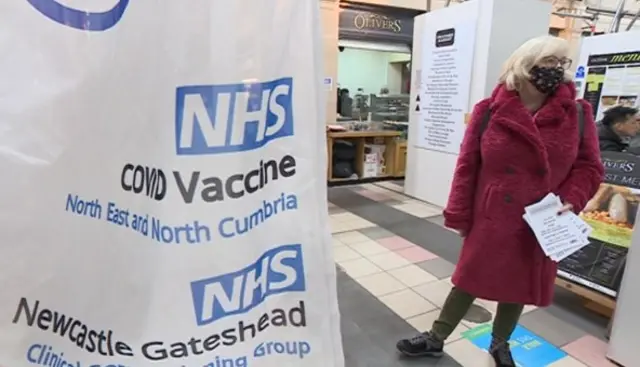 Health worker with leaflets about the Covid pop-up clinic