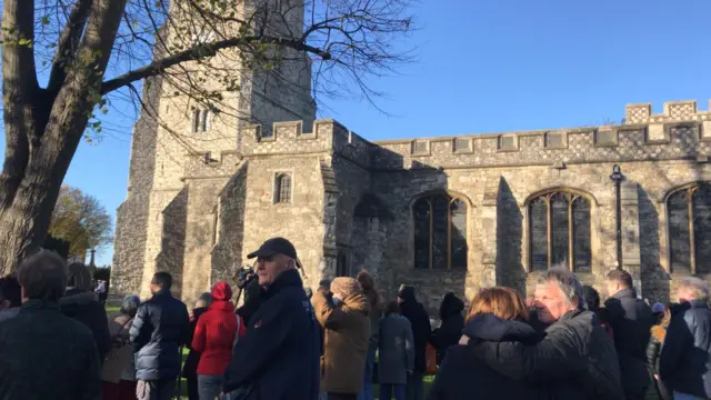 Members of the public standing outside St Mary's Church