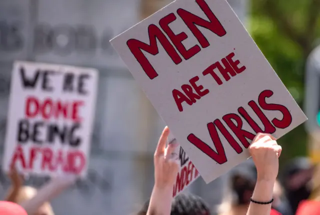 A protester holds up a placard