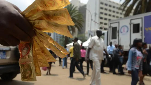 An Aids Healthcare Foundation-Kenya worker distributes condoms in the streets of Nairobi