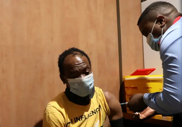 A man is vaccinated inside the Transvaco coronavirus disease (COVID-19) vaccine train