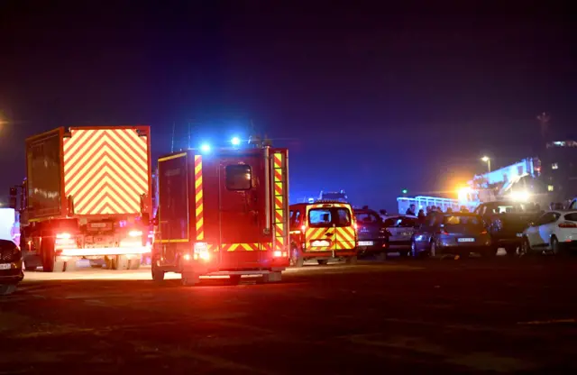 Fire trucks arriving at Calais harbour after migrants died in the sinking of their boat off the coast of Calais.