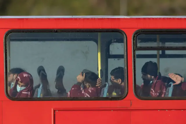 Migrants sit on a bus awaiting transfer, after arriving at Dover port on November 25