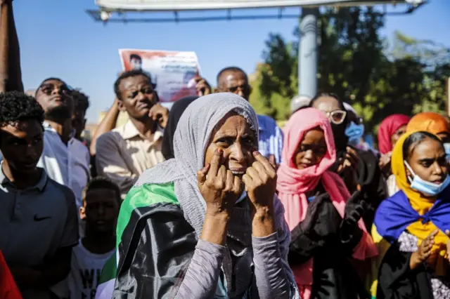 Woman holding her hands to her face