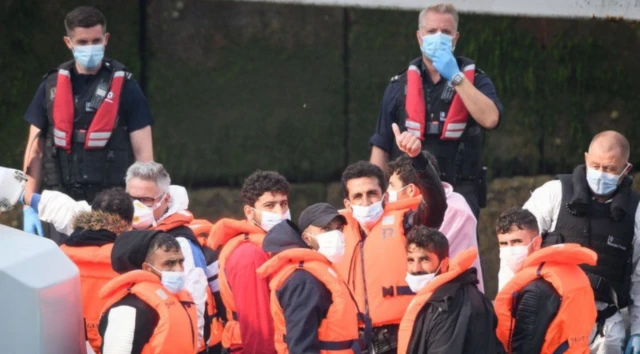 Migrants arrive in the UK after crossing the English Channel