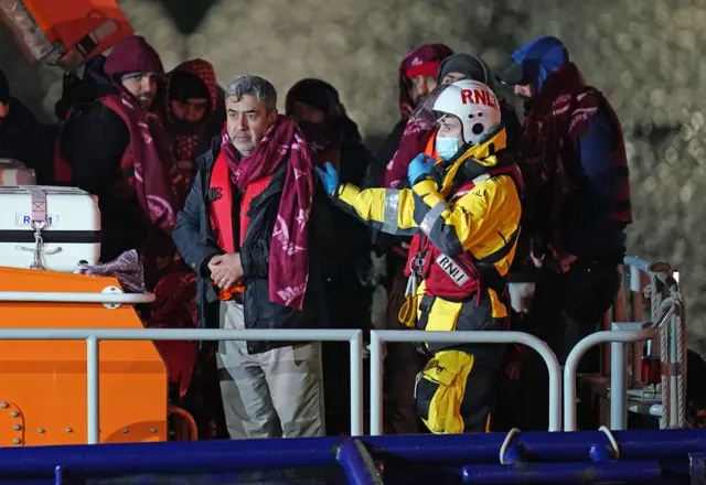 A group of people thought to be migrants are brought in to Dover, Kent, by the RNLI,