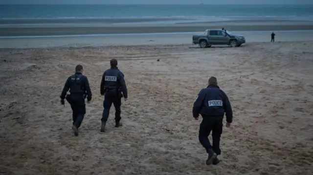 French Police patrol the beach of Wimereux on Thursday searching for migrants