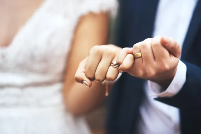 Married couple holding hands on wedding day