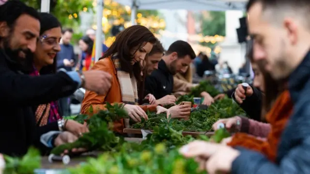 People making Christmas wreaths