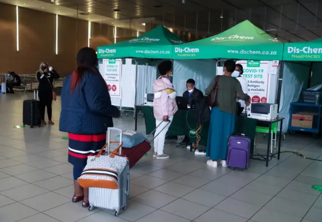 Passengers queue to get a PCR test before travelling on international flights, at O.R. Tambo International Airport in Johannesburg, South Africa.