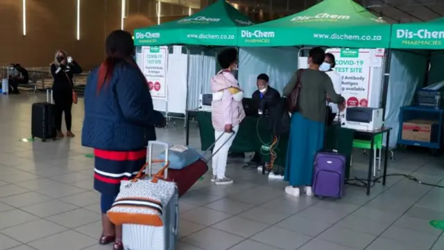 Passengers queue to get a PCR test against the coronavirus disease (COVID-19) before traveling on international flights, at O.R. Tambo International Airport in Johannesburg, South Africa