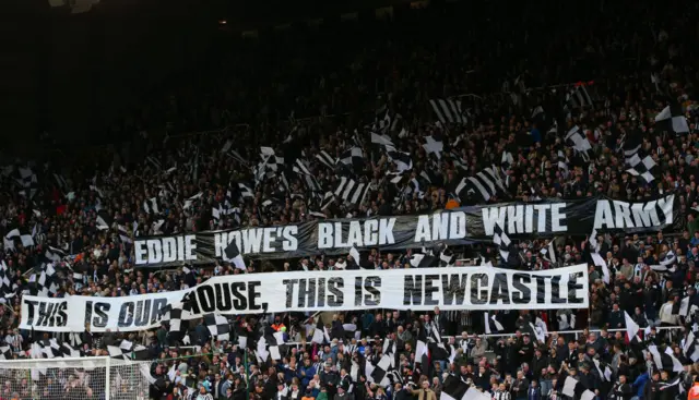 Newcastle United crowd with Eddie Howe banner