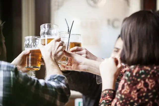 People drinking in a pub