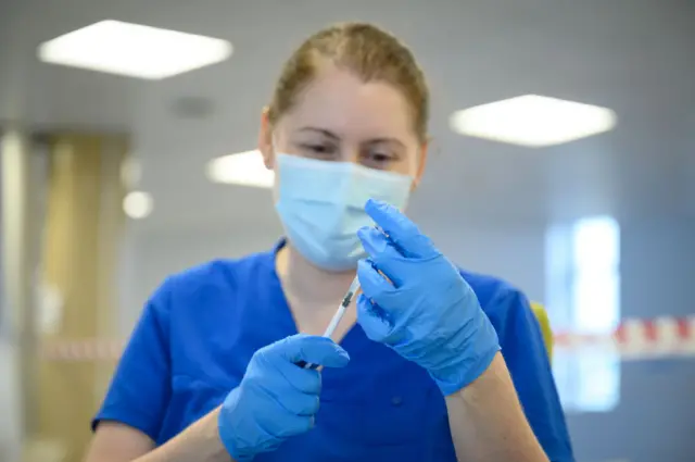 A health worker preparing a Covid vaccine