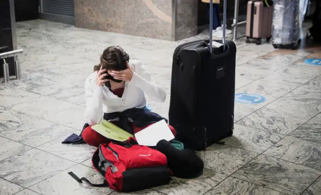 Woman inside Tambo international airport on phone