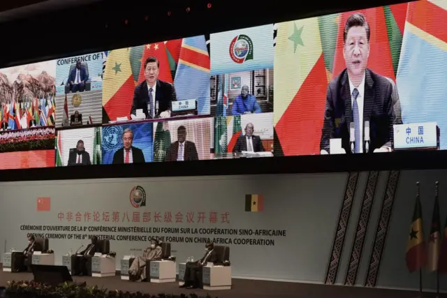 Chinese President Xi Jinping (on the screen) delivers his speech during the China-Africa Cooperation (FOCAC) meeting in Dakar, Senegal,