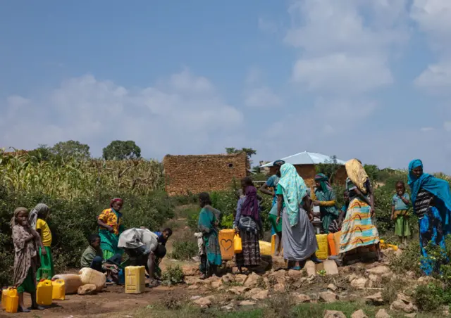 Ethiopian people pumping water in a well