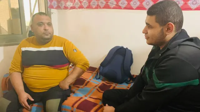 Abu Mansour al-Dajni (L) at his home in the Gaza Strip