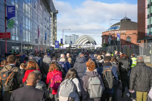 Hundreds of people queue to get into the COP26 venue