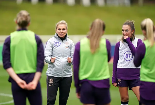 Sarina Wiegman talks to her England players during training