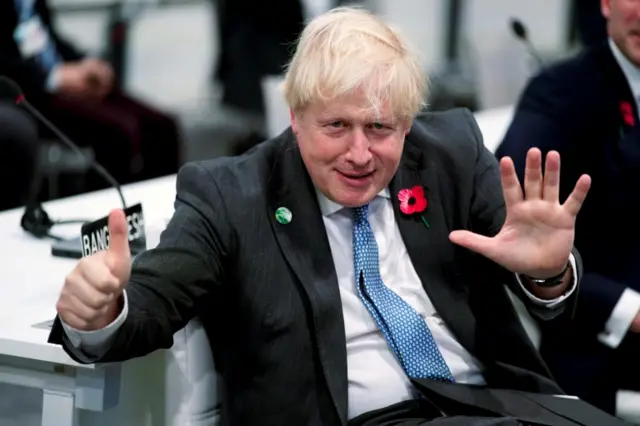 British Prime Minister Boris Johnson gives a sign he called the 1.5 sign, during the "Accelerating Clean Technology Innovation and Deployment" event