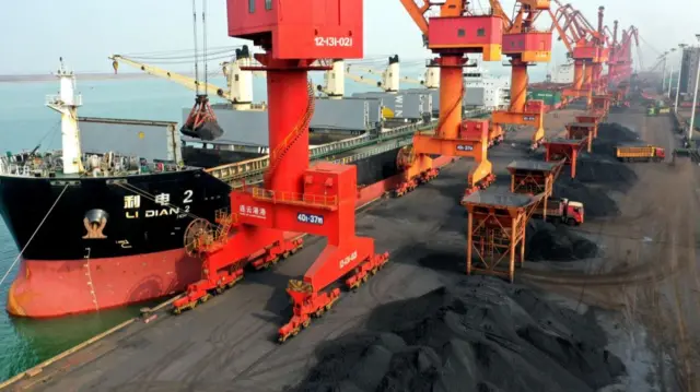 Coal is offloaded from a freighter ship in China