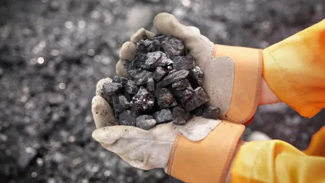 Hands holding coal