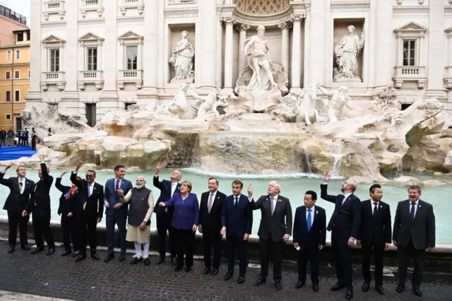 G20 leaders stand in front of the Trevi fountain