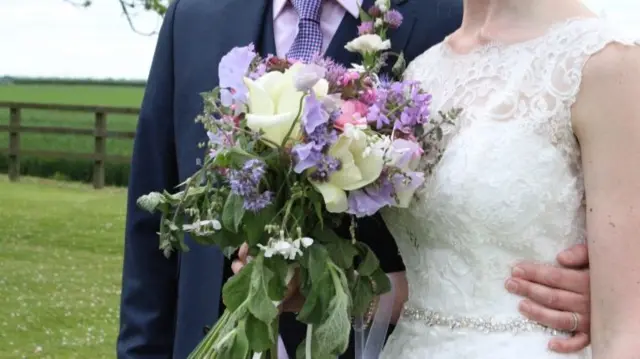 Newlyweds and bouquet