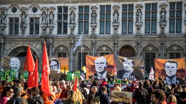 In France, climate action activists display portraits of world leaders