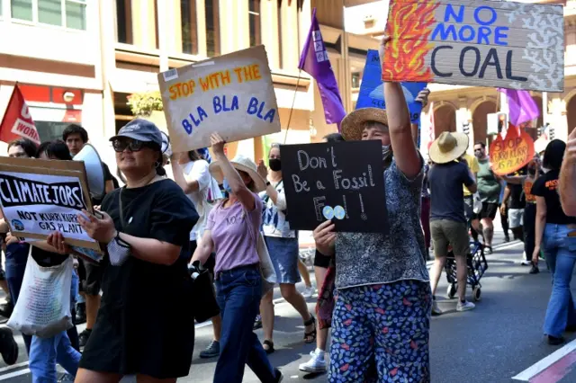 Protesters marched with signs during the climate rally in Sydney