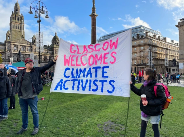 The marchers are being applauded by locals as they arrive in George Square