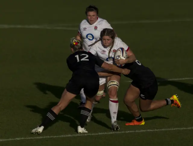 Poppy Cleall being tackled by New Zealand players