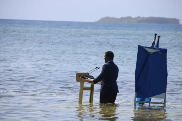 Foreign Affairs Simon Kofe gives a COP26 statement while standing in the ocean in Funafuti, Tuvalu