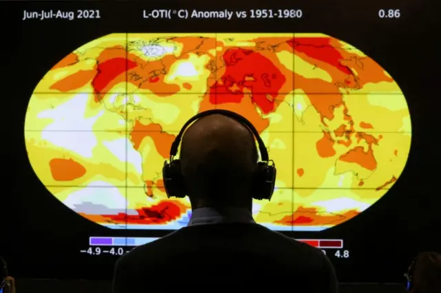 A delegate looks at a screen during the UN Climate Change Conference (COP26)