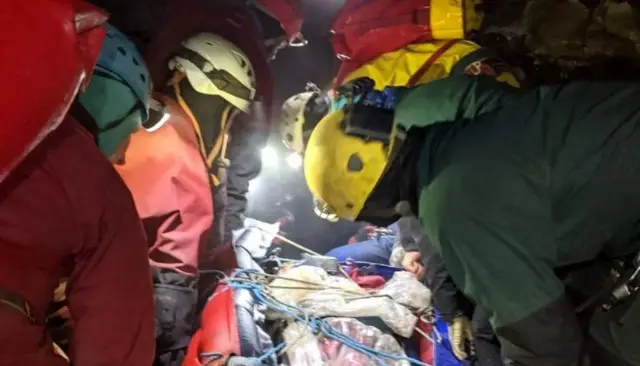 Rescuers with victim of fall