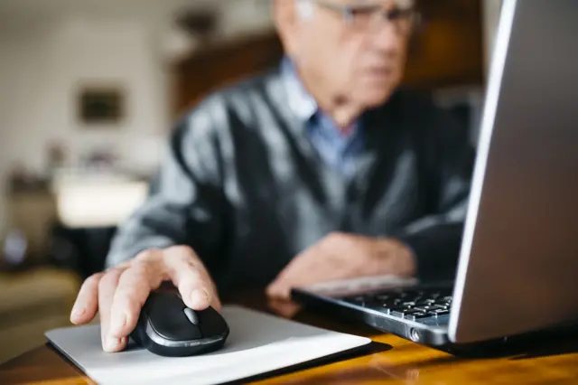 A stock image of a man using a computer