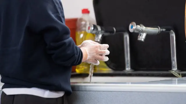 A child washes their hands at school