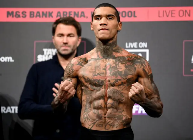 Conor Benn poses on the scales