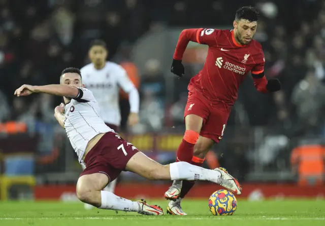 Alex Oxlade-Chamberlain (R) of Liverpool in action against John McGinn (L) of Aston Villa