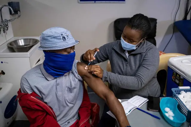 A patient gets vaccinated against COVID-19 in Johannesburg