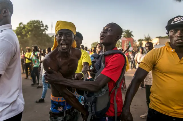 A supporter of the opposition United Democratic Party (UDP) chants slogans during a protest.