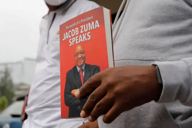 Jacob Zuma Foundation spokesperson Mzwanele Manyi holds copy of a book titled Jacob Zuma Speaks