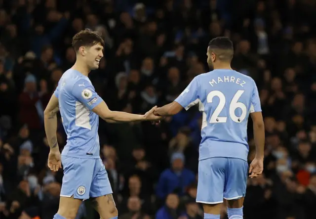Riyad Mahrez with John Stones after scoring for Manchester City