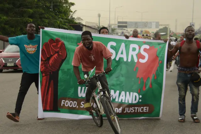 Protesters chant slogan songs during a protest to commemorate one year anniversary of #EndSars, a protest against a military attack on protesters at Lekki tollgate in Lagos, Nigeria, on October 20, 2021.