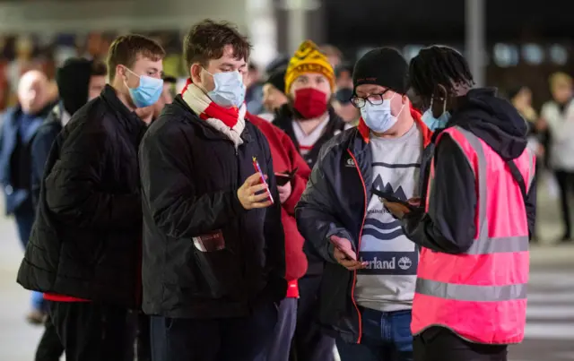 Arsenal fans showing their passes on 15 December