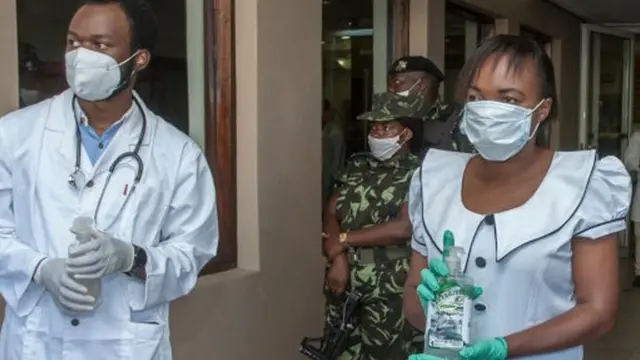 Blantyre District Health Office Medical Staff and armed policemen wear face masks to as a preventive measure against the spread of the COVID-19 coronavirus as they wait for delegates at Mount Soche hotel in Blantyre on May 6, 2020